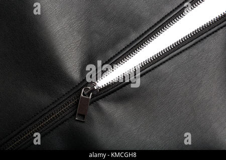 opened zip on black leather surface Stock Photo
