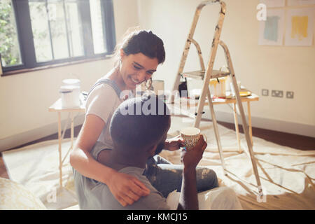 Affectionate young couple painting living room Stock Photo