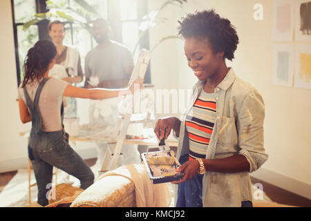 Woman with paint roller painting living room Stock Photo