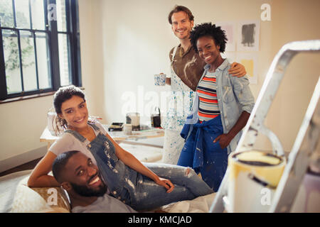 Portrait smiling couples painting living room Stock Photo