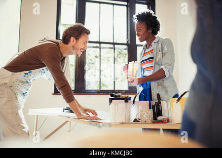 Couple viewing paint swatches, painting living room Stock Photo