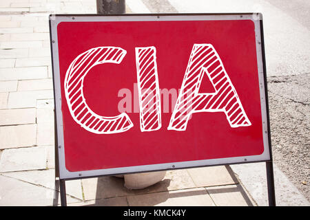 Hand writing text caption inspiration showing CIA concept meaning Abbreviation written on old announcement road sign with background and space Stock Photo