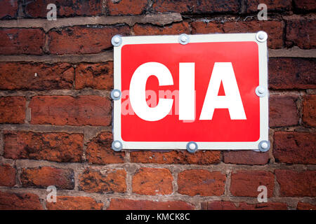 Hand writing text caption inspiration showing CIA  concept meaning Abbreviation written on old announcement road sign with background and space Stock Photo