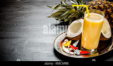 Cocktail pina colada. Making cocktail with pineapple, coconut and rum on the chalkboard . Free space for text. Stock Photo