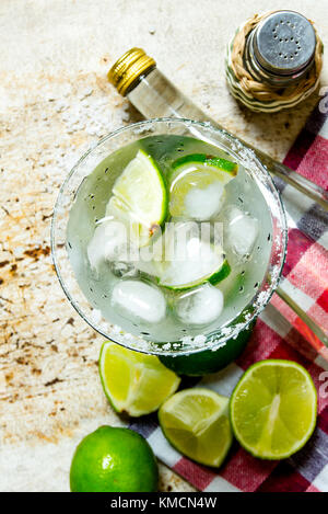 Cocktail Margarita . Ingredients cocktail - limes, ice , tequila, salt and liqueur on the old background .  Top view Stock Photo