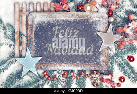 Decorated blackboard with text 'Feliz Navidad', or 'Merry Christmas' in Spanish Stock Photo