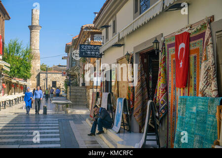Carpet shop, alley at the old town Kaleici, at the end the Kesik Minare, Broken Minaret, Antalya, turkish riviera, Turkey Stock Photo