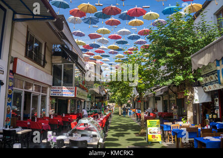 Outside gastronomy at umbrella street, 2.Inoenue Sokak, Kaleici, old town of Antalya, turkish riviera, Turkey Stock Photo