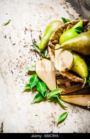 Pears in a basket with leaves. On rustic background. Stock Photo