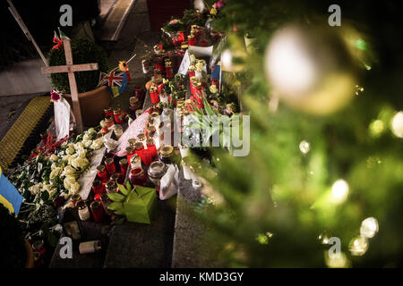 Berlin, Germany. 06th Dec, 2017. Several candles stand in front of the Memorial Church at the Breitscheidplatz square in Berlin, Germany, 06 December 2017. Credit: Sophia Kembowski/dpa/Alamy Live News Stock Photo