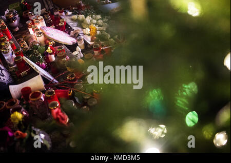 Berlin, Germany. 06th Dec, 2017. Several candles stand in front of the Memorial Church at the Breitscheidplatz square in Berlin, Germany, 06 December 2017. Credit: Sophia Kembowski/dpa/Alamy Live News Stock Photo