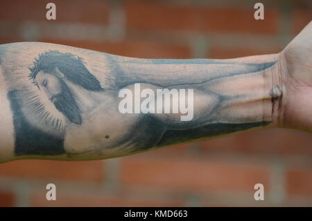 Medellin, Colombia. 7th Mar, 2017. Jhon Jairo Velásquez alias 'Popeye', former hitman for Colombia's drug lord Pablo Escobar, shows his Jesus tattoo at a hotel in Medellin, Colombia, 7 March 2017. Velásquez, responsible for killing more than 250 people, has just fininshed his 23 year prison sentence and has now the intention of joining politics. Credit: Georg Ismar/dpa/Alamy Live News Stock Photo