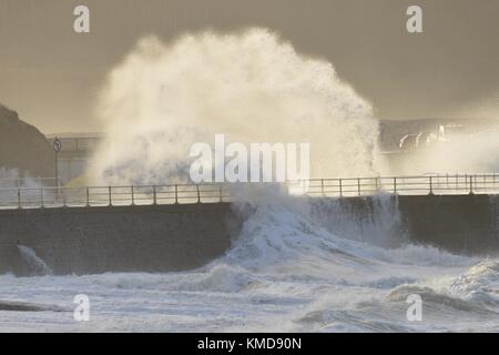 Aberystwyth Wales UK, Thursday 07 December 2017  UK Weather: The southern edge of Storm Caroline, with winds gusting between 40 and 60 mph, brings huge waves crashing into the sea defences  in Aberystwyth, Ceredigion , west Wales UK.  Very cold and wintry weather is forecast for the coming days, with heavy snow and icy conditions spreading down from the north. Met Office ‘yellow’ warnings have been issued, and there is a risk of disruption to travel in many areas   photo © Keith Morris/ Alamy Live News Stock Photo