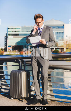 picture of a businessman in the city who reads documents Stock Photo