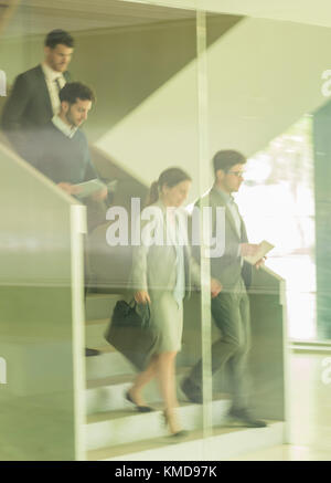 Business people walking,descending stairs in office Stock Photo