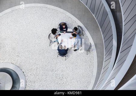 View from above architects meeting in atrium courtyard Stock Photo