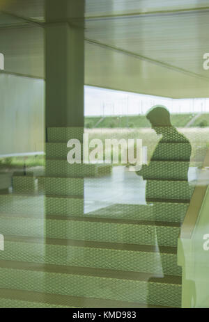 Silhouette businessman texting with smart phone in office Stock Photo