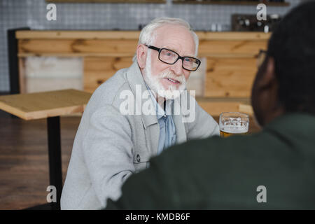 senior friends talking and drinking beer Stock Photo