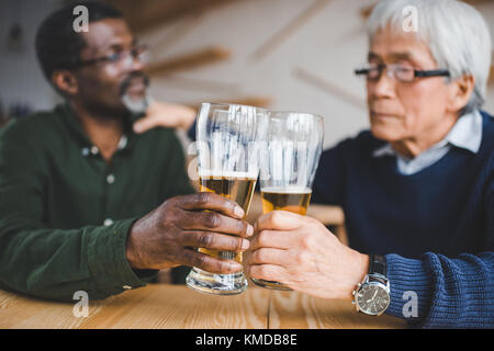 senior friends clinking glasses Stock Photo