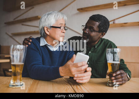 senior friends drinking beer  Stock Photo