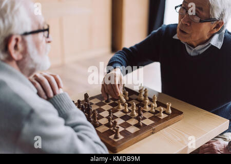 senior men playing chess Stock Photo