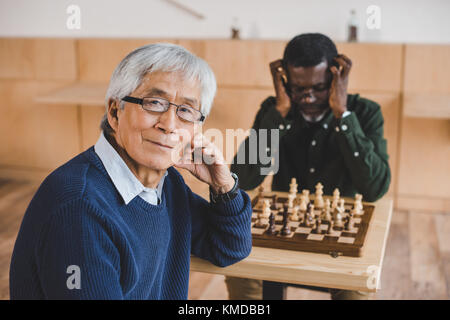 asian man playing chess Stock Photo