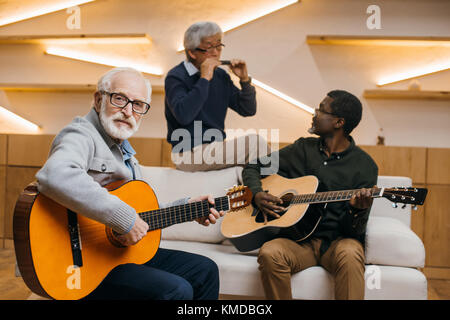senior friends playing music Stock Photo