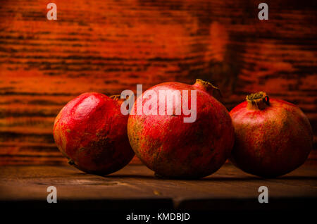 ripe pomegranate on wooden boards. juicy pomegranate on wooden boards. Stock Photo