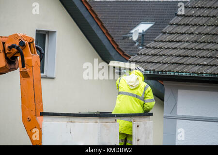 Electrician repairing street lights on a lift Stock Photo