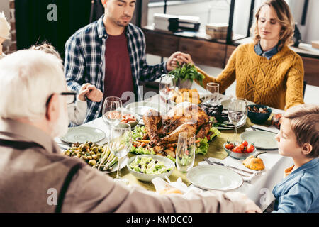 family holding hands and praying on thanksgiving Stock Photo