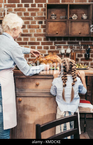grandmother and granddaughter with turkey for thanksgiving Stock Photo