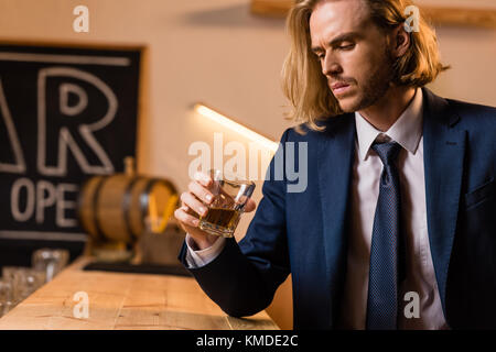 businessman drinking whisky in bar Stock Photo