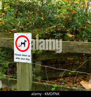 Clean up after your dog notice in a wooded area popular with dog walkers, United Kingdom Stock Photo