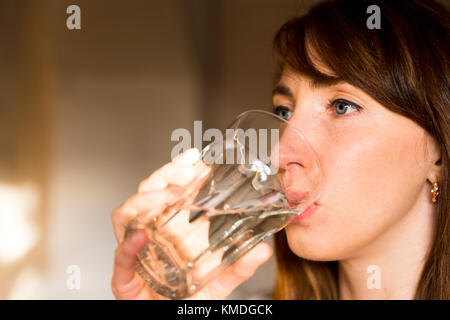 Female drinking from a glass of water. Health care concept photo, lifestyle, close up Stock Photo