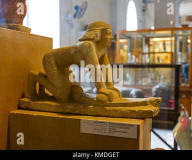A model or statuette of a woman grinding corn inside the Egyptian Museum, Cairo, Egypt, North Africa Stock Photo
