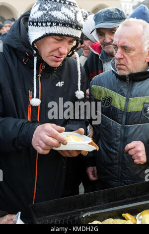 CRACOW, POLAND - DECEMBER 20, 2015:  Christmas Eve for poor and homeless on the Central Market in Cracow. Every year the group Kosciuszko prepares the Stock Photo