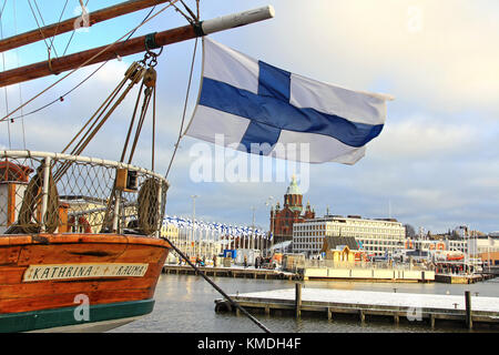 HELSINKI, FINLAND - DECEMBER 6, 2017: View on the Market Square of Helsinki with the flag of Finland on a vessel and 100 Finnish flags and the Uspensk Stock Photo