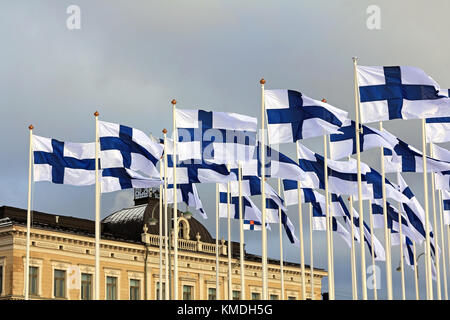 HELSINKI, FINLAND - DECEMBER 6, 2017: Installation of one hundred flags for 100-year-old Finland on Helsinki Market Square with the Presidential Palac Stock Photo