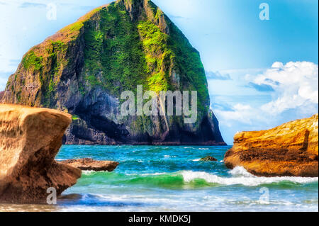 Cape Kiwanda geological feature and landmark, haystack rock, surrounded by the waters of the Pacific Ocean.  View seen from the beach at Pacific Cit Stock Photo