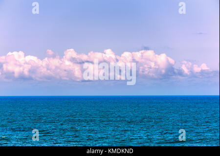 A simplistic view of the Pacific Ocean and the sky with clouds. Stock Photo