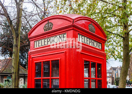 Traditional red British K2 telephone box, designed by Sir Giles Gilbert Scott, in South Grove, Highgate Village, London, UK Stock Photo