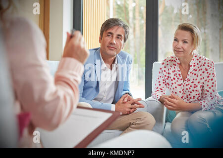 Couple listening to therapist in couples therapy counseling session Stock Photo
