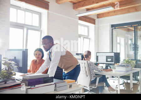 Businessman and businesswoman using computer in office Stock Photo