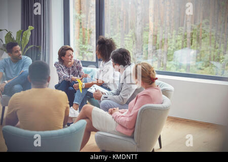 Women talking in group therapy session Stock Photo