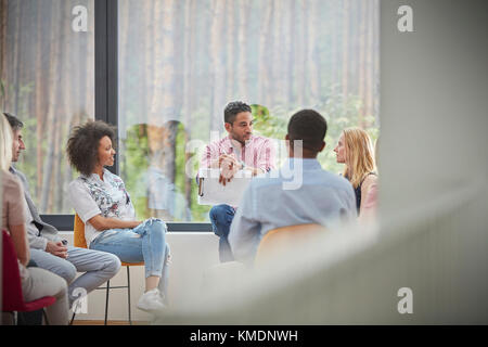 People talking in group therapy session Stock Photo