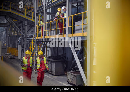 Steelworkers talking and walking in steel mill Stock Photo