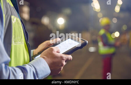 Close up steelworker supervisor using digital tablet in steel mill Stock Photo
