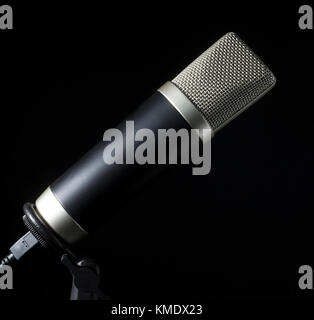 Mike with a silver head on its stand on a black background Stock Photo