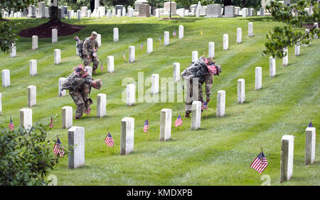 U.S. Army Old Guard soldiers place flags on headstones at the Arlington National Cemetery for Memorial Day May 25, 2017 in Arlington, Virginia. (photo by Elizabeth Fraser  via Planetpix) Stock Photo