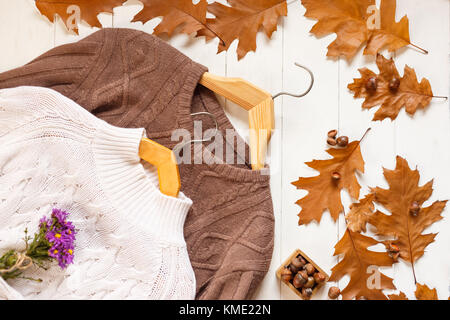 cropped view of knitted burgundy and white sweaterson, top view Stock Photo